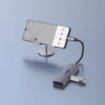 Een smartphone op een standaard verbonden met de hub en een USB-stick, waarop bestandsbeheer wordt getoond.